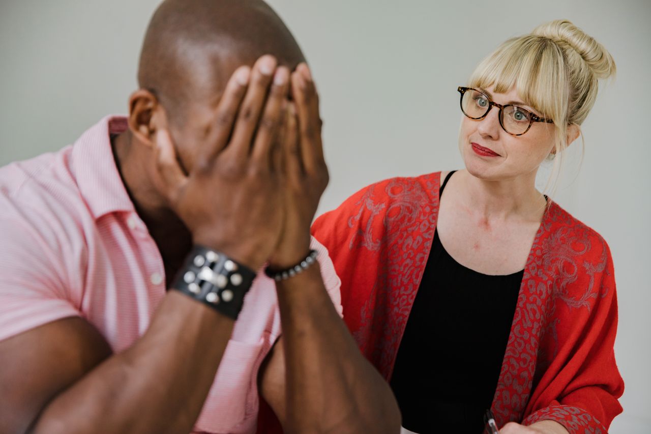 Home A supportive counseling session between a caring mentor and an emotional individual.